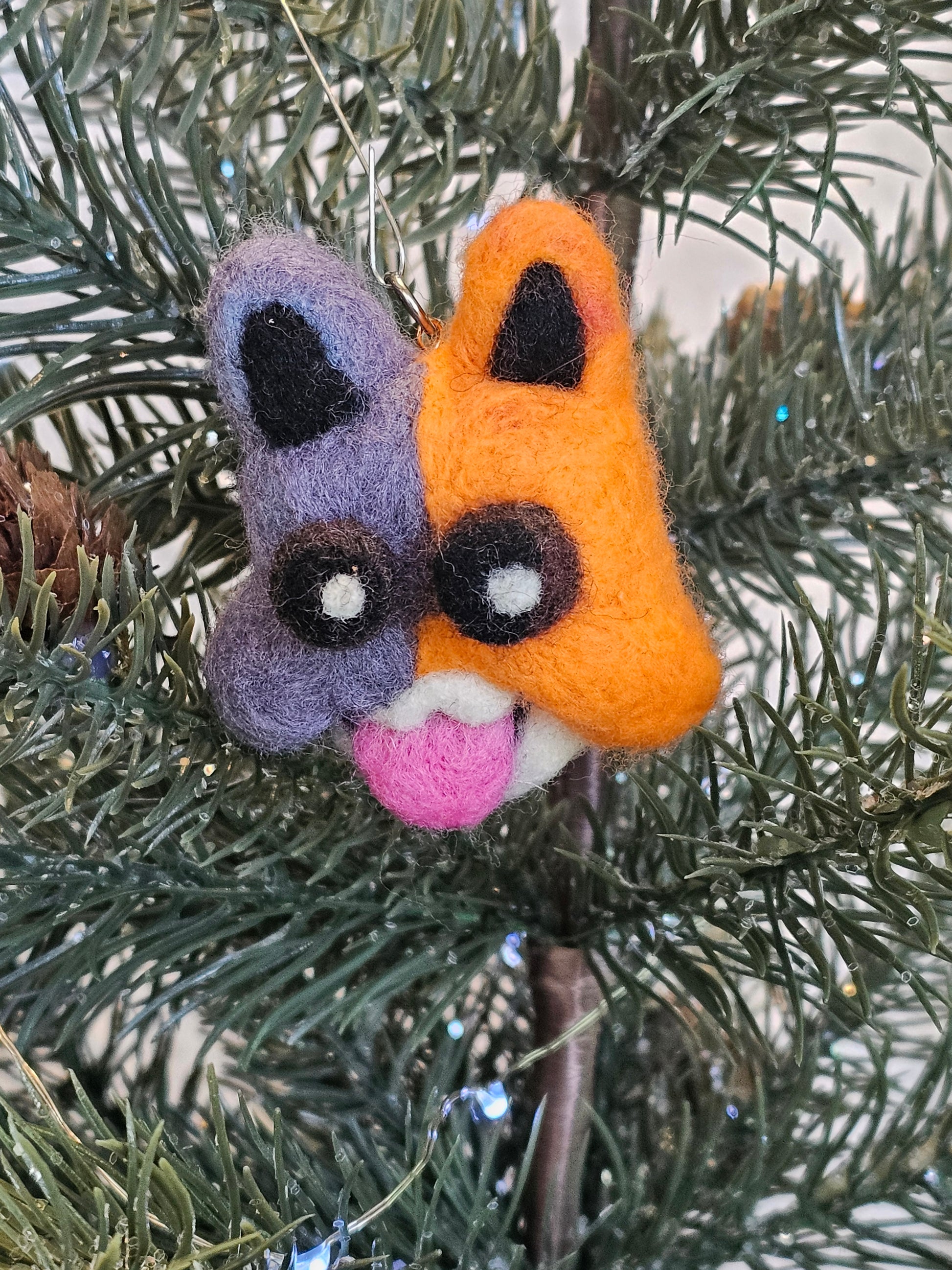 Meowscles' head in a Christmas tree. Meowscles is a Grey and Orange cat from Fortnite.